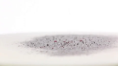 Red ground pepper added to milk. Super closeup, slow motion Stock Footage 76150189