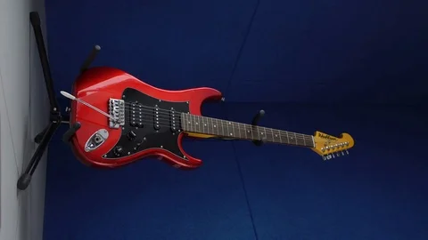 Red guitar on a blue background Stock Footage 82843558