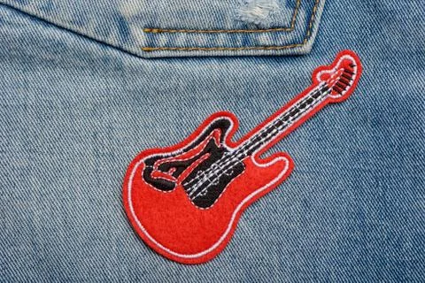 Red guitar patch on jeans 写真素材