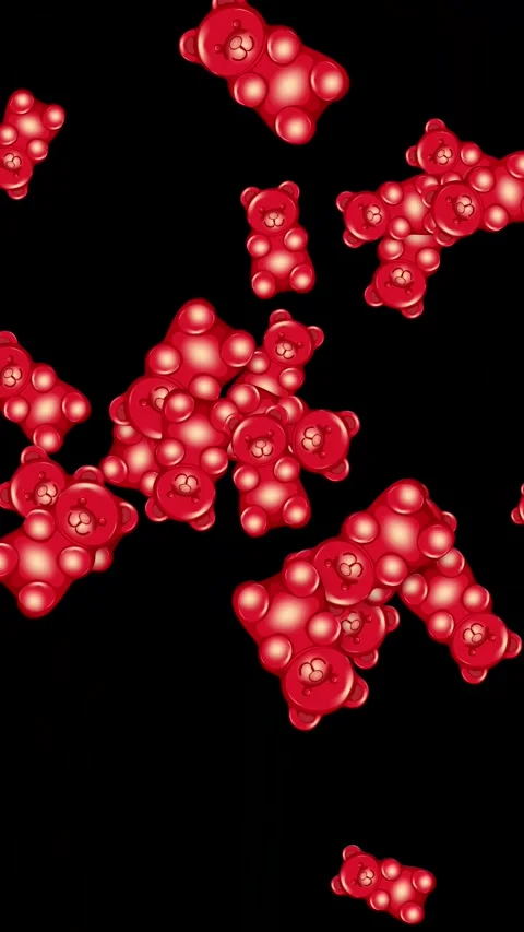 Red Gummy Bear Candy Falling Against a Solid Black Background Stock Footage 344843468