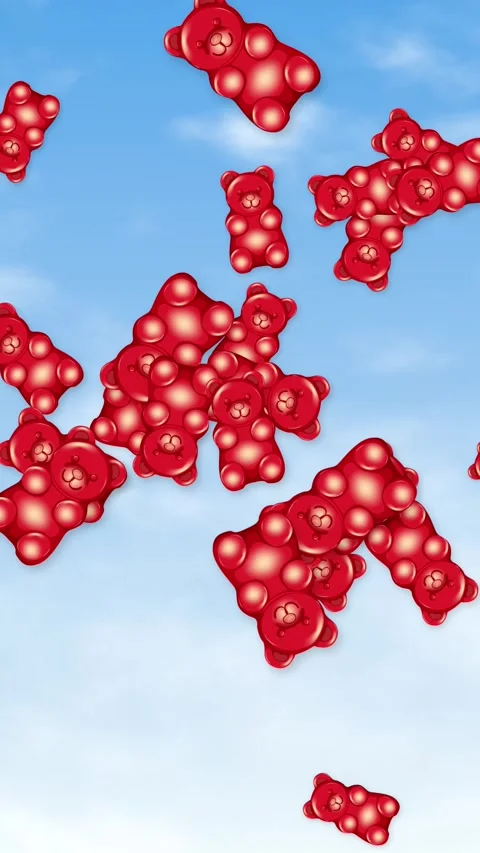 Red Gummy Bears Falling Through a Bright Blue Sky Background Stock Footage 344622510