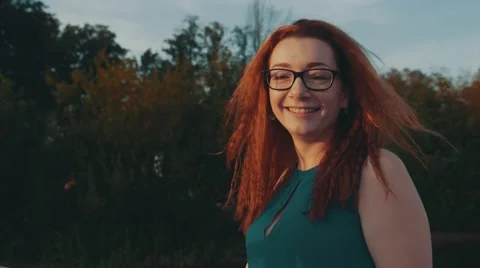 Red hair girl in glasses on motor boat. Summer evening. Entertainment. Smile Stock Footage