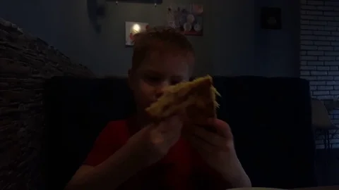 Red-Hair Young Boy Eats Pizza in a Cafe-Pizzeria Video stock 75013497