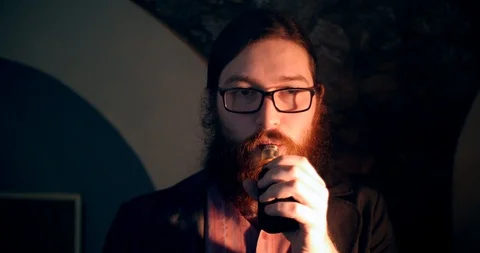 Red-haired beard is smoking a wipe and disappears 4k magic focus Stock Footage 87324610