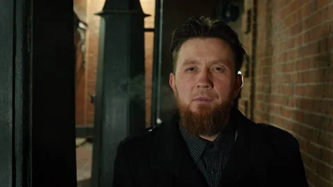 Red-haired bearded man smoking, looking to camera Stock Footage 228095451