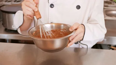 Red-haired boy in chef's costume cooks pancakes in kitchen, kneads dough Stock Footage 197066207