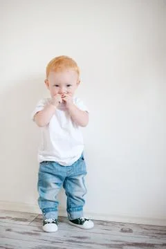 Red-haired boy in a white T-shirt Stock Photos