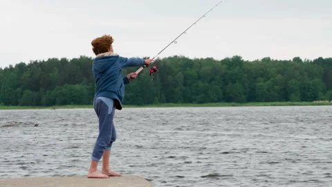 Red-haired Curly Boy with a Spinning Rod HD Stock Footage 140173517