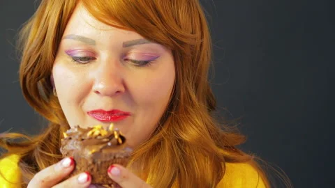 Red-haired Girl in a cafe at the table eating cakes. Stock Footage 112530451