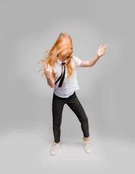 Red-haired girl dancing, while her long hair completely covers her face Stock Photos