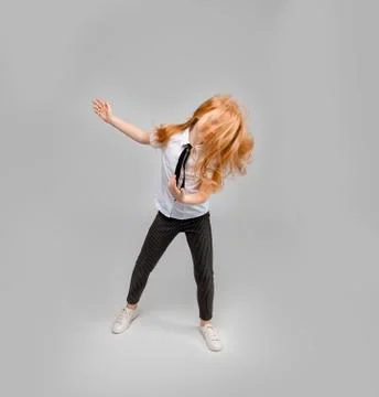 Red-haired girl dancing, while her long hair completely covers her face Stock Photos