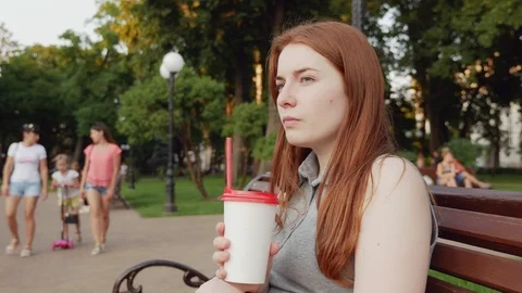 Red-haired girl drinks coffee and smiles Stock Footage 112973397