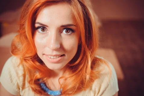 Red-haired girl looking at the camera Stock Photos