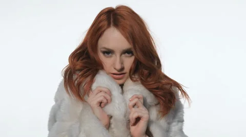 Red-haired girl posing in a white fur coat Video stock 35184773