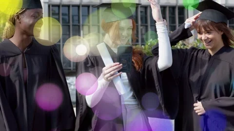 Red-haired grad raising phone and tapping, drawing peers, bokeh fading, showing Stock Footage 332981876