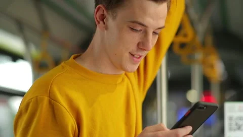 Red-haired guy with freckles on his face in the light yellow sweater stands in Stock Footage 133429798