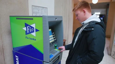 The red-haired guy is using an ATM machine Circulation of electronic money. Stock Footage 149624550