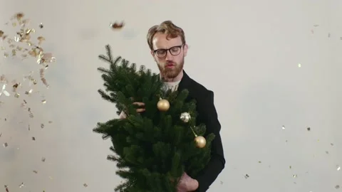 Red-haired handsome man dances with a Christmas tree. Stock-Footage 221642852