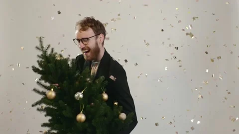 Red-haired handsome man dances with a Christmas tree. Stock-Footage 221642883