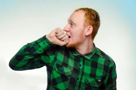 Red haired man bite his fist, hand. shocked, caucasian male teenager. surprised Stock Photos
