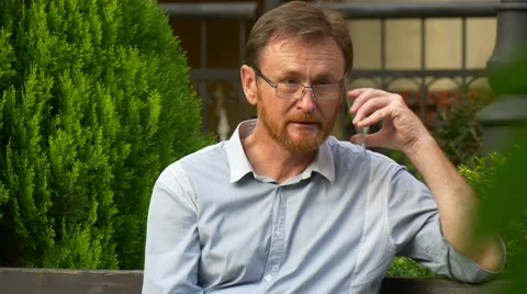 Red-Haired Man Holding a Transparent Smartphone Stock Footage 67553273