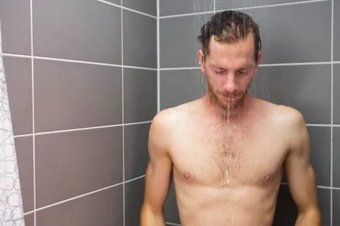 Red-haired man taking a shower Stock Photos