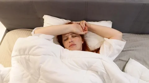 Red haired middle aged woman trying to sleep, insomnia and sleep problems Stock Footage 310357939