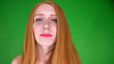 Red haired model girl with make up smiling and kissing with red lips. Stock Footage 117869251
