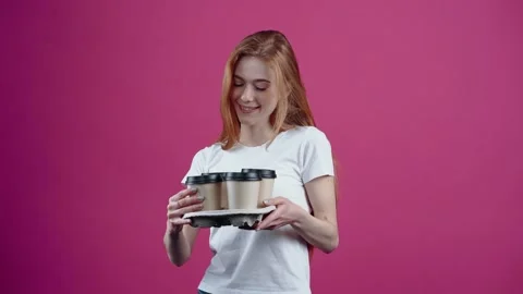 The red-haired, optimistic, charismatic student, with four coffees in her hand Video stock 154771175