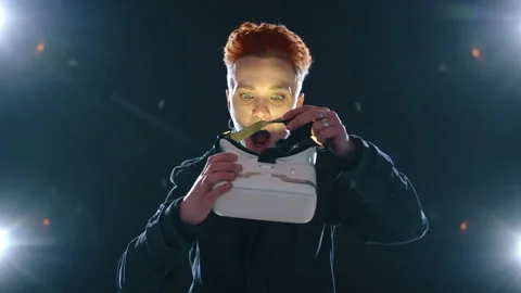 Red-Haired Person Trying VR Headset with Green Light Illumination Stock Footage 263850591