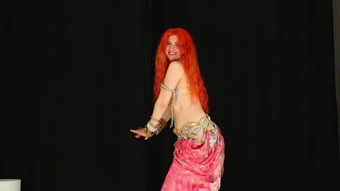 Red-haired sexy woman dancing oriental dance in the studio Stock Footage 317913402
