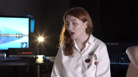 Red-haired singer singing in a music studio. Closeup Stock Footage 138463455