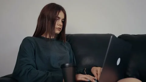 The red-haired student frantically types a message on her laptop, receives a Stock Footage 159499392