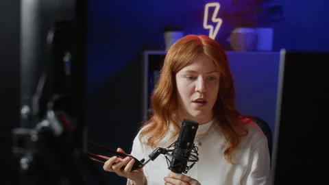 Red Haired Woman Setting Up Microphone for Stream Stock Footage 332727885