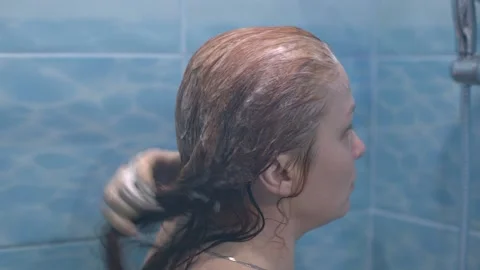 Red-haired woman washes in the shower, hair and skin care Stock Footage 146688198