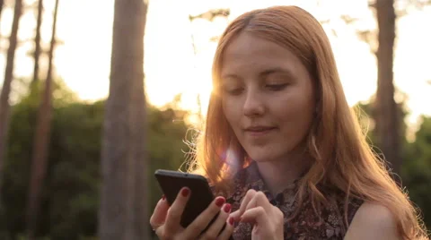 Red-haired young girl using cell phone 스톡 동영상 65398412