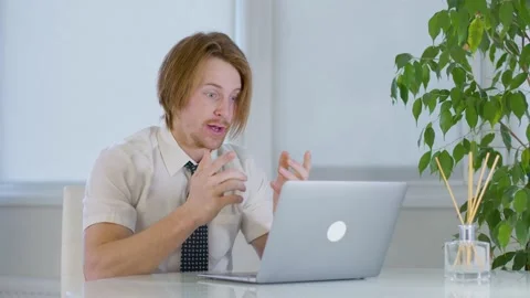 Red-haired young male worker in office.get angry screaming during a video call 스톡 동영상 239270684