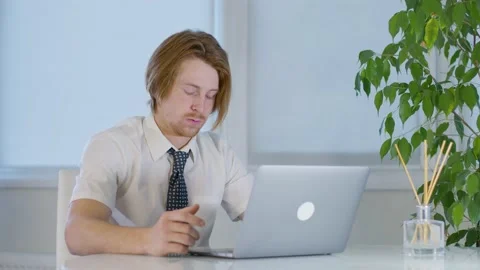 Red-haired young male worker in the office.talking loudly video call.screaming Stock-Footage 239270880