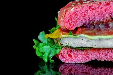 Red hamburger on a black background macro Foto stock
