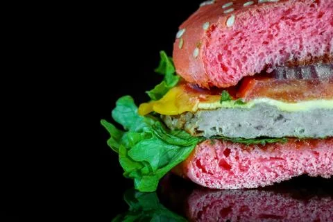 Red hamburger on a black background macro Stock Photos