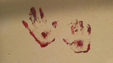 Red hand prints, met on a wall in Liguria, Italy Stock Photos