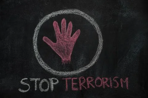 Red hand shape and stop terrorism text in the circle on black chalkboard Stock Photos