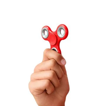 Red hand spinner. Boy playing a popular toy fidget spinner in his hand. Stres Stock Photos