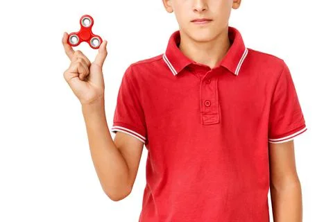 Red hand spinner. Boy playing a popular toy fidget spinner in his hand. Stres Stock Photos