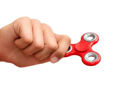 Red hand spinner. Boy playing a popular toy fidget spinner in his hand. Stres Stock Photos