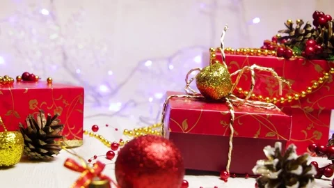 Red handmade gift boxes and New Year's decorations, golden apples and bumps with Video stock 82406615