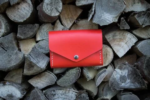 Red handmade leather wallet on firewood background Stock Photos