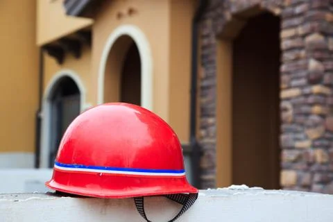 Red hard hat on a wal Stock Photos