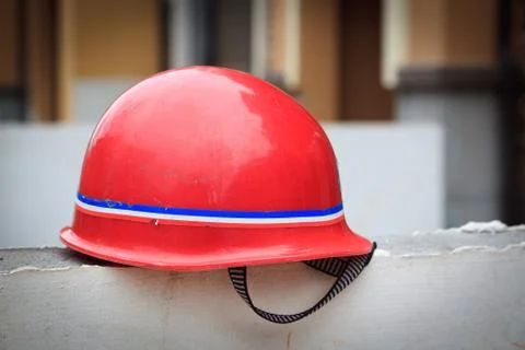 Red hard hat on a wal Stock Photos