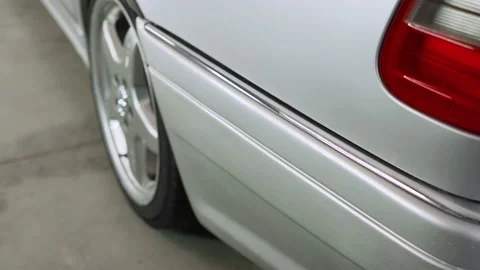 Red headlight of a silver car close-up. Video stock 186752340